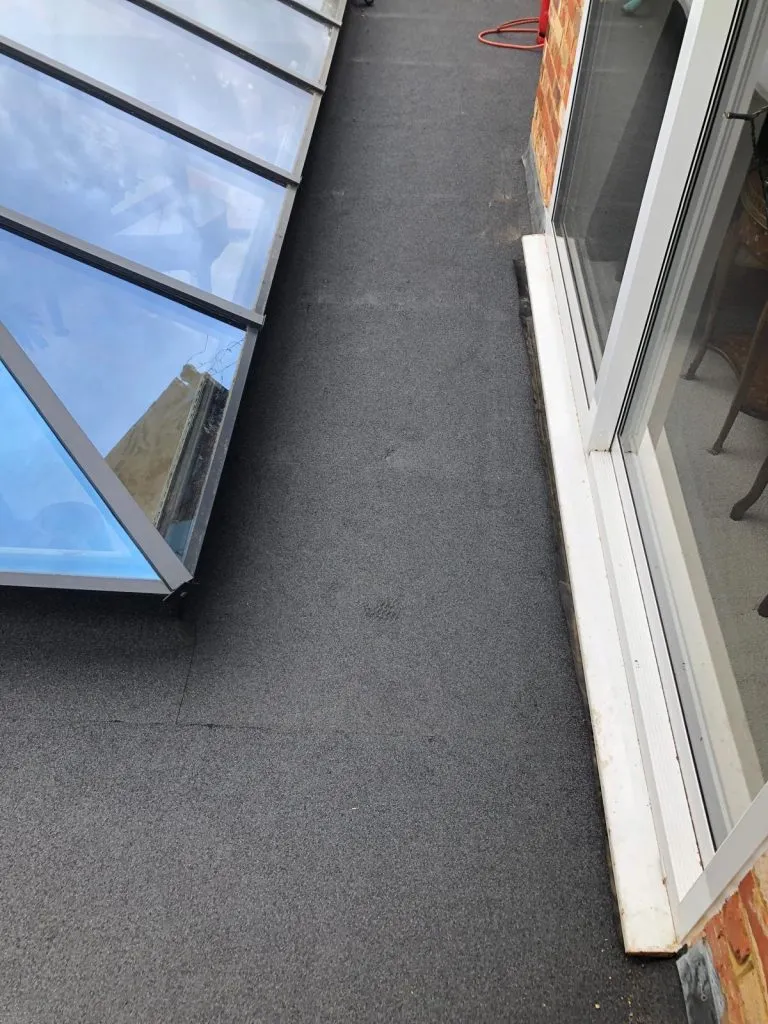 a view of a roof with a skylight and a window